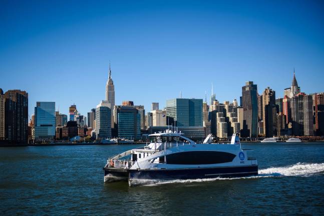 With the Empire State Building as a backdrop, a NYC Ferry vessel heads southbound down the East River opposite East 34th Street. A major expansion of the city&#x2019;s ferry system kicking off on Aug. 15 will connect the East 90th Street landing near Carl Schurz Park with Wall Street by way of 34th Street. Photo: NYC Ferry