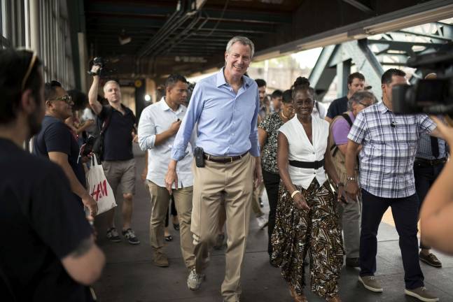 After yet another calamity amid the summer heat wave, a second subway derailment, Mayor Bill de Blasio and wife Chirlane McCray head for a press conference on board the F train in Park Slope, Brooklyn, on Sunday, July 23. Photo: Ed Reed / Mayoral Photo Office, via flickr