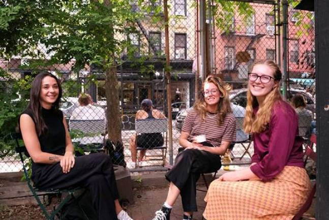 Mira Seyal (far left), Hannah Waltz (middle) and Valentine Sargent (far right) hanging out at the Elizabeth Street Garden on 211 Elizabeth Street. Photo: Beau Matic.