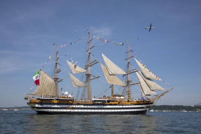 Amerigo Vespucci, the 331-foot long tall ship of the Italian Navy, with aircraft pictured flying above.