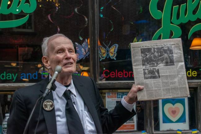 Holding up a preserved New York Times obituary page, Randy Wicker, the last remaining member of the “Sip-In” protest, told the crowd on April 21, 2022 that he’s been photographed twice in the New York Times obituary section and is still here today. Photo: Leah Foreman