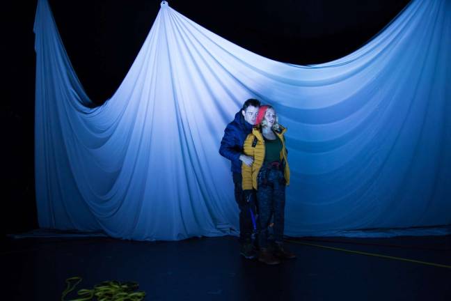 Actos huddle as they portray climbers in the freezing Himalayas. Photo: Joe Loper