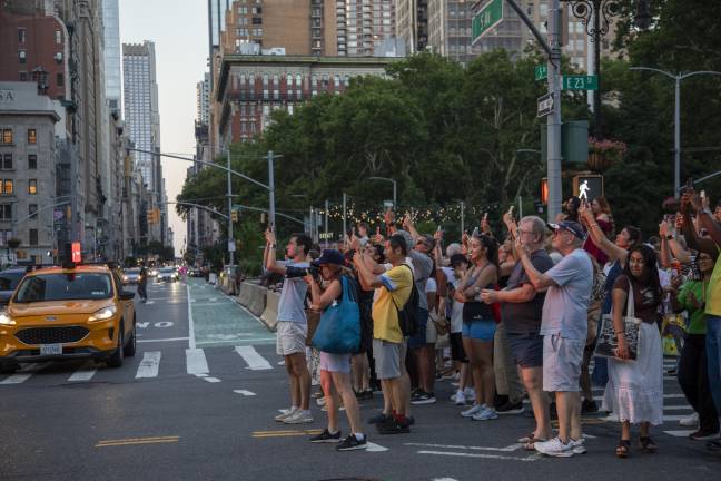 Spectators blocked East 23rd Street and Fifth Ave. right around the peak viewing time at 8:21 p.m., in a bid to get a center of the road glimpse of the setting sun.