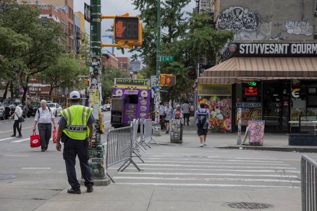 NYPD and NYC Transit officials stood by the enclosed entrance to First Avenue on 14 Street, redirecting vehicles away from the zone.