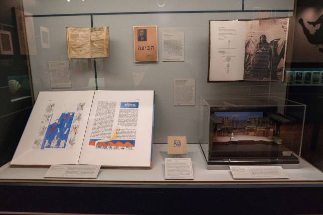 Some of the items at the New York Public Library's “What’s New? Recent Acquisitions" exhibit. Pictured at the upper left is one of six extant copies of “Confessionario Para Los Curas de Indios,” which is among the oldest books printed in the Americas. On the bottom right is a set model for Lin-Manuel Miranda’s Off-Broadway production of “In the Heights.” Photo: Jonathan Blanc/NYPL