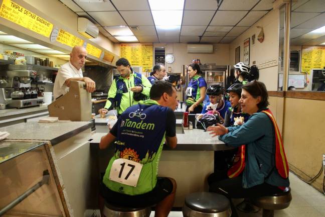 Cyclists, and their host, at Alpha Donuts in Sunnyside, Queens, the second stop during InTandem’s Late Night Donut Ride on Sept. 29. Photo: Ariana Giulia Reichler