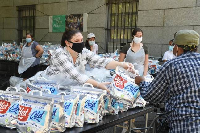 Food distribution outside in warmer weather. Photo courtesy of Archives, Cathedral of St. John the Divine