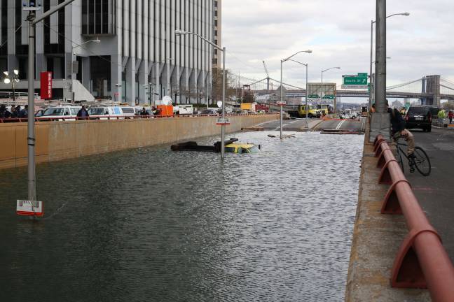 Recovery and resiliency efforts undertaken since Superstorm Sandy include steps to prevent tunnels like the Battery Park Underpass, pictured here during Sandy, from flooding during future storms. Photo: Timothy Krause via Flickr