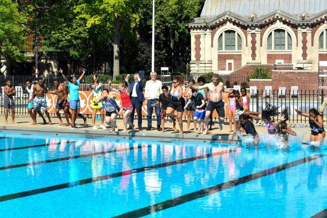 NYC Parks Commissioner Sue Donoghue jumps into Hamilton Fish Pool along with local kids and community members on June 28th. Photo: NYC Parks / Daniel Avila