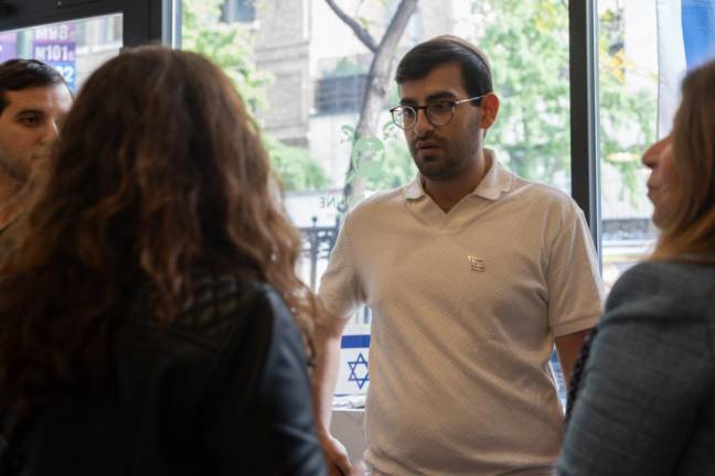 Aaron Dahan, the owner of Caffe Aronne seen talking to customers and community members. (Priyanka Rajput)