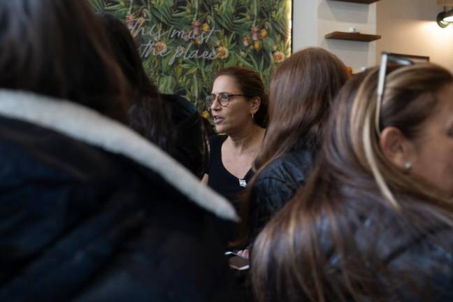 Aaron Dahan's mother, Peggy Dahan stepped in to help her son. When Dahan called his mom on Nov. 7 to inform her about closing the cafe. She stood firm and said, I'm not letting anybody close your shop. Eventually, she came in and helped manage the shop. Here, she's seen intereacting with customers in the crowded shop. (Priyanka Rajput)