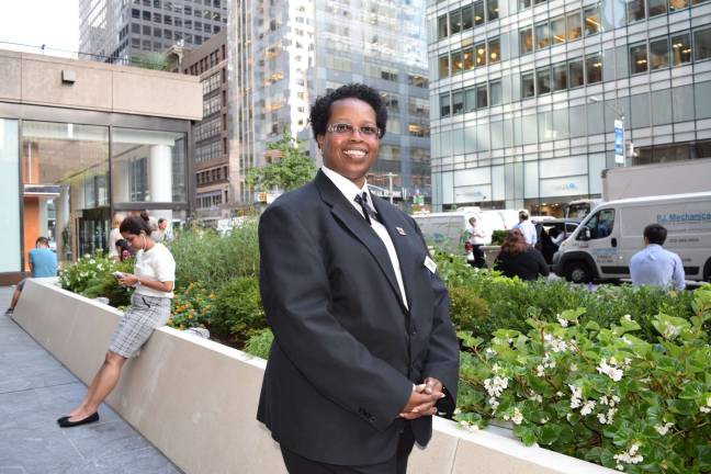 Cheryl Pennant stands in a garden area of the office building where she is a security officer.&#xa0;Photo: Genia Gould