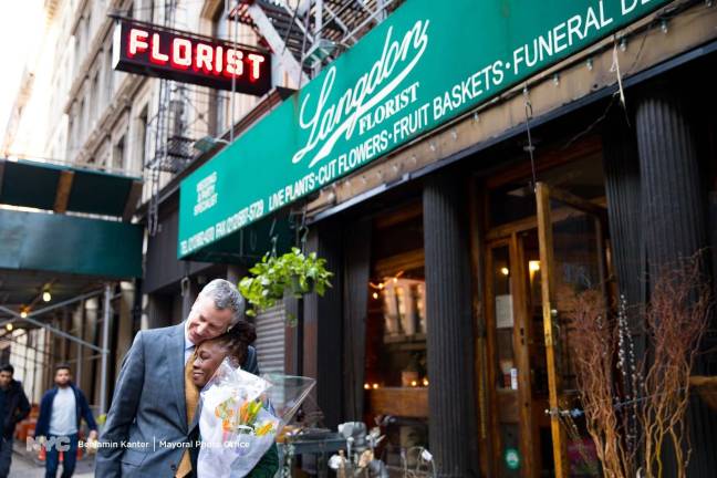 First lady Chirlane McCray, holding a bouquet of wildflowers, and Mayor Bill de Blasio pay a fond farewell to Langdon Florist near City Hall on February 27. The 71-year-old institution – which they've patronized for more than a quarter-century and which supplied the flowers for their wedding in 1994 – is relocating to Staten Island. Photo: Benjamin Kanter, via Mayoral Photo Office