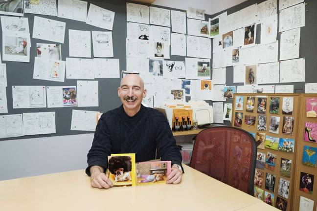 Dave Laubach, Avanti Press Director of Design, with this year's LOUIE Award nominations, The Pug in the Afro Wig and Exercise Cat. Photo: Ryan Segedi  