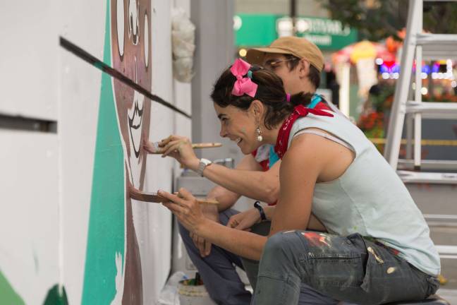 Chin&ograve;n Maria and a colleague at work on “One World, Our Children” in Albany Plaza. Photo: Scott Townell 