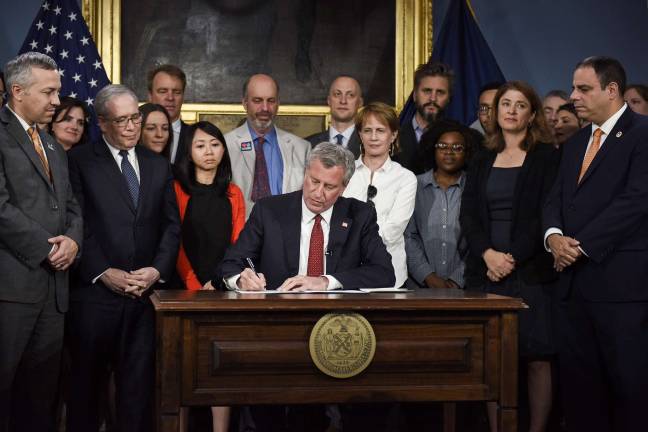 Mayor Bill de Blasio signing an executive order June 2 pledging that New York City will remain committed to reducing greenhouse gas emissions despite President Trump's withdrawal from the Paris climate agreement. Photo: Ed Reed/Mayoral Photography Office