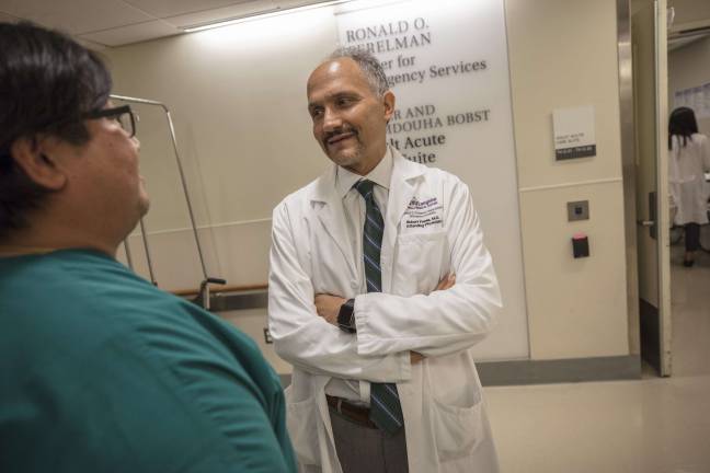 Dr. Rob Femia, chair of the Ronald O. Perelman Department of Emergency Medicine at NYU Langone Health, discusses a patient case with his colleague. Photo: Andrew Neary