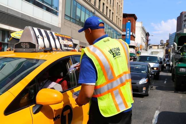 A VisionZero? Street Team last month handed out information to pedestrians, cyclists and drivers in Manhattan. Photo by NYC Dept. of Transportation