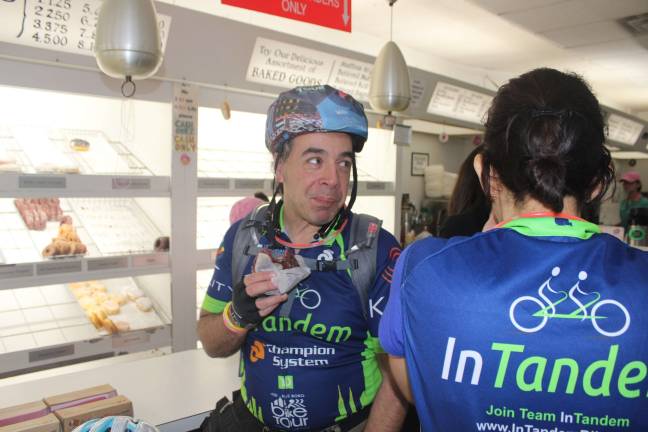 Cyclists at Peter Pan Donut &amp; Pastry Shop in Greenpoint, Brooklyn, <saxo:ch value="226 128 168"/>the first stop during InTandem’s Sept. 29 Late Night Donut Ride. Photo: Ariana Giulia Reichler