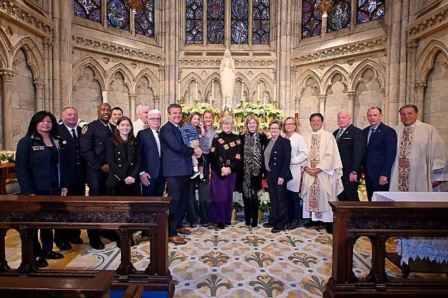 At the Detective Steven McDonald Memorial Mass, the McDonald family and Police Commissioner Tisch (center).