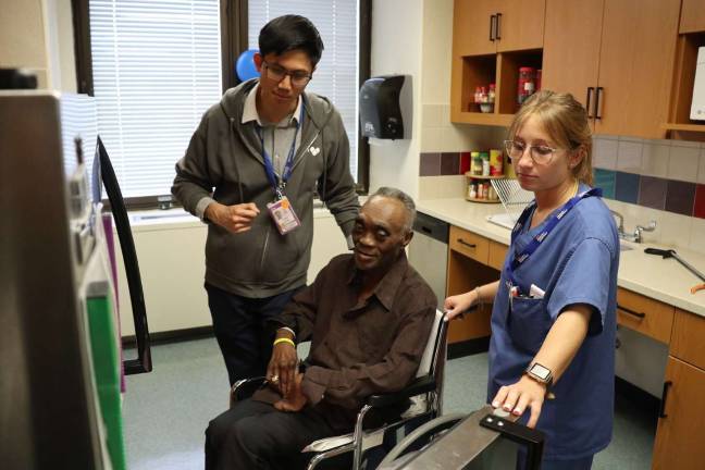 Rosentha Tamaklo (center), a patient in the Rehabilitation Medicine Service at NYC Health + Hospitals/Bellevue, with occupational therapists. Photo: NYC Health + Hospitals/Bellevue