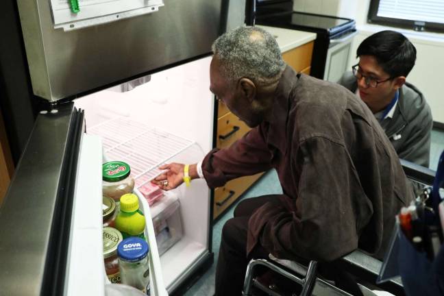 Rosentha Tamaklo, a patient in the Rehabilitation Medicine Service at NYC Health + Hospitals/Bellevue, with occupational therapists. Photo: NYC Health + Hospitals/Bellevue