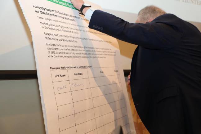 US Senate Majority Leader Chuck Schumer signs the petition for the Equal Rights Amendment.