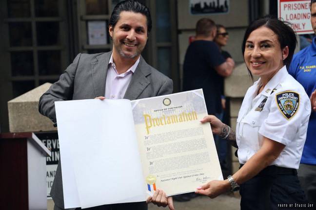 Captain Pamela A. Jeronimo, commanding officer of the 9th Pct., accepts a proclamation from Mayor Eric Adams presented by deputy mayor Fabien Levy.