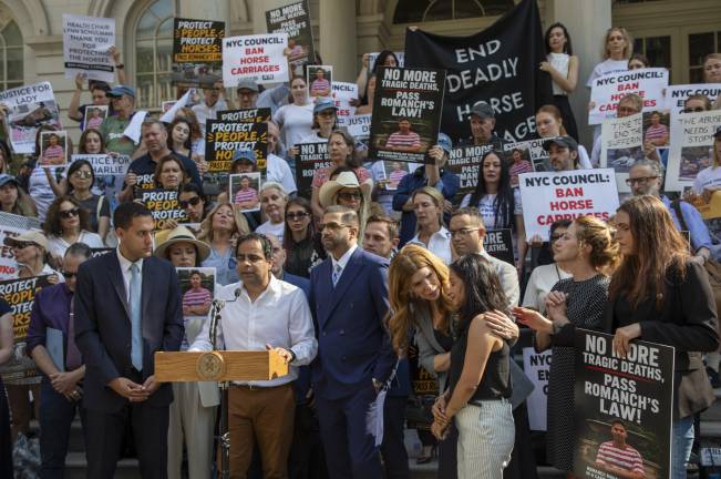 City Council Speaker Julie Menin, who publicly supported the bill introduced by CM Christopher Marte (left), comforted the aunt of Romanch Mahajan, the teen who died after falling from a horse earlier this summer, on the steps of city hall.