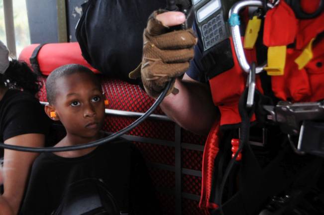 A child looks up at Staff Sgt. Ryan R. Dush, with the 103rd Rescue Squadron of the 106th Rescue Wing assigned to the New York Air National Guard, while flying in an HH-60 Pave Hawk helicopter over the Houston area, August 30, 2017. The child was safely dropped off to the Montagne Center in Beaumont, Texas. Photo: Airman 1st Class Daniel H. Farrell, New York National Guard, via flickr