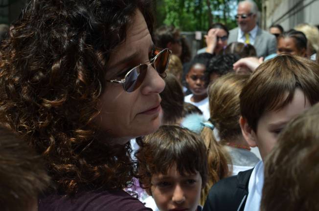 Dana Lerner, mother of Cooper Stock, embraces her son's former classmates at the Cooper Stock Way street renaming. Photo by Daniel Fitzsimmons.
