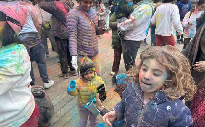 Kids join in the fun at the festival of Holi.