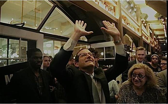 Micah Lasher throws his arms up in celebration.