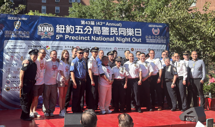 5th Precinct Officers, including Commanding Officer Lam, pose for a picture alongside NNO volunteers.