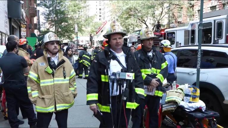 Deputy Assistant Chief James Canty, center, said three firefighters suffered minor injuries but that the blaze was quickly extinguished, preventing its spread to adjoining buildings.