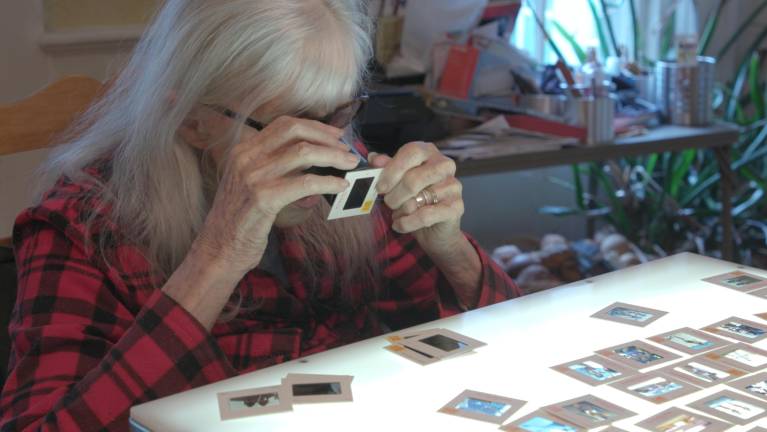 Just like the old days at Sports Illustrated, Jule pours over the slides that she had taken on location with a loupe. Even as someone in her mid-90s, she had the facilities to look and remember. The documentary has footage from her 96th Birthday.