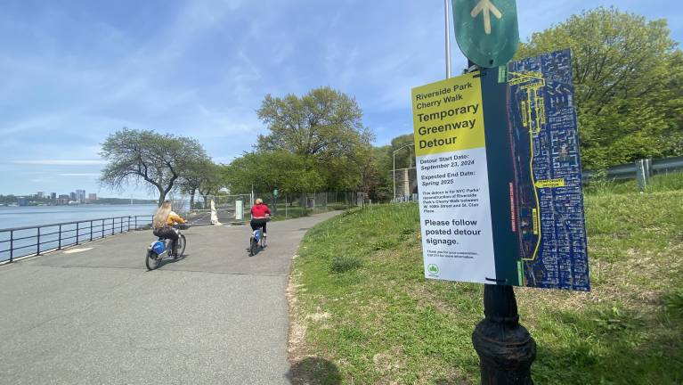 People taking the detour after seeing the sign and the fencing blocking their way while Cherry Walk was repaired.