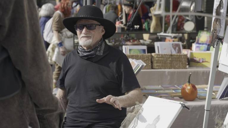 Peter Robinson Smith sells his artwork at Grand Bazaar Market on Oct. 31, 2021. (Photo: Xintian Wang)