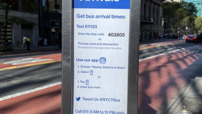 Bus sign indicates how to find out arrival times. Photo: Meredith Kurz