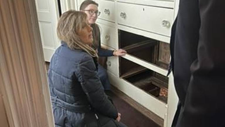 The bottom two drawers of the dresser are removed to expose the hidden passageway