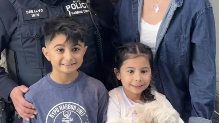 Hudson a two year old Maltese who was rescued from the East River by the NYPD Harbor was adopted by the DeSalvo family including Jared DeSalvo (left rear), his wife Nicole and their two children Salvatore (front left) and Stella. NYPD Officer DeSalvo was one of the cops who rescued Hudson on March 30.