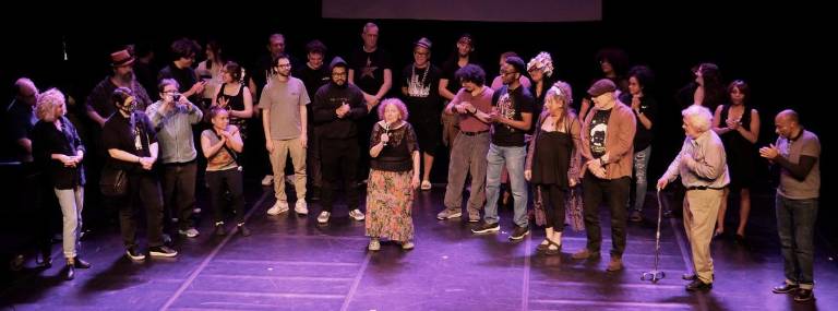 Crystal Field (center), the long time director of the Theater for the New City with the staff and performers at Lower East Side Festival of the Arts in 2023.