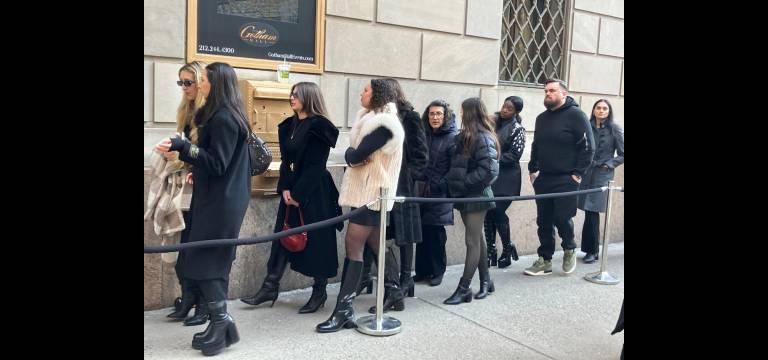 Black high-heeled boots are a must for women attending New York Fashion Week at Gotham Hall.