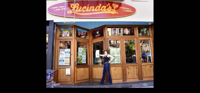 Karen Rempel points the way to Lucinda’s honky-tonk juke joint at 169 Avenue A.