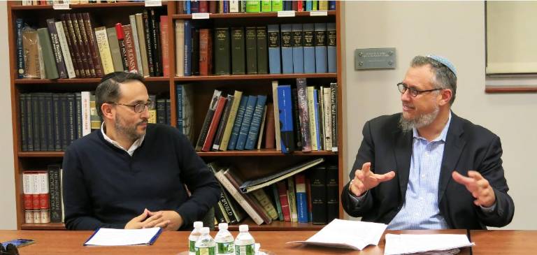 Rabbi Scott N. Bolton (right) discusses the Talmud with a student.