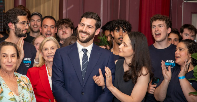 Alex Bores (center), wife Diane (right) and and many supporters on primary night June 23.