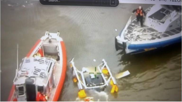 Firefighter Michael Prokop prepares to descend into the overturned helicopter in a valiant, but ultimately unsuccessful, attempt to save some of the six victims trapped inside.