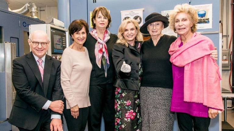 Rep. Carolyn Maloney (center, holding coin) co-sponsored legislation authorizing the sale of commemorative coins to raise money for breast cancer research. Photo: Patrick Lyn
