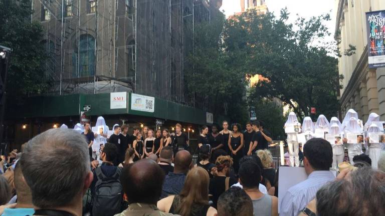 The Montclair High School acapella group Passing Notes delivered an emotional rendition of "Hallelujah" during Monday evening's commemoration in Greenwich Village for the Pulse nightclub massacre victims. They were flanked by veiled figures standing in for the 49 victims of the shooting. Photo: Claire Wang