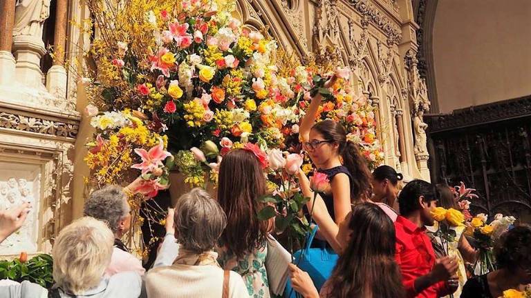 At Trinity Church, the Rev. Dr. William Lupfer invited congregants to take a flower home after the last service of Easter Sunday. Photo: Trinity Church Wall Street/James Melchiorre